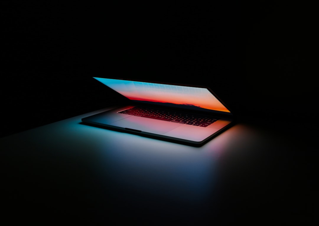 Person typing on laptop with legal documents