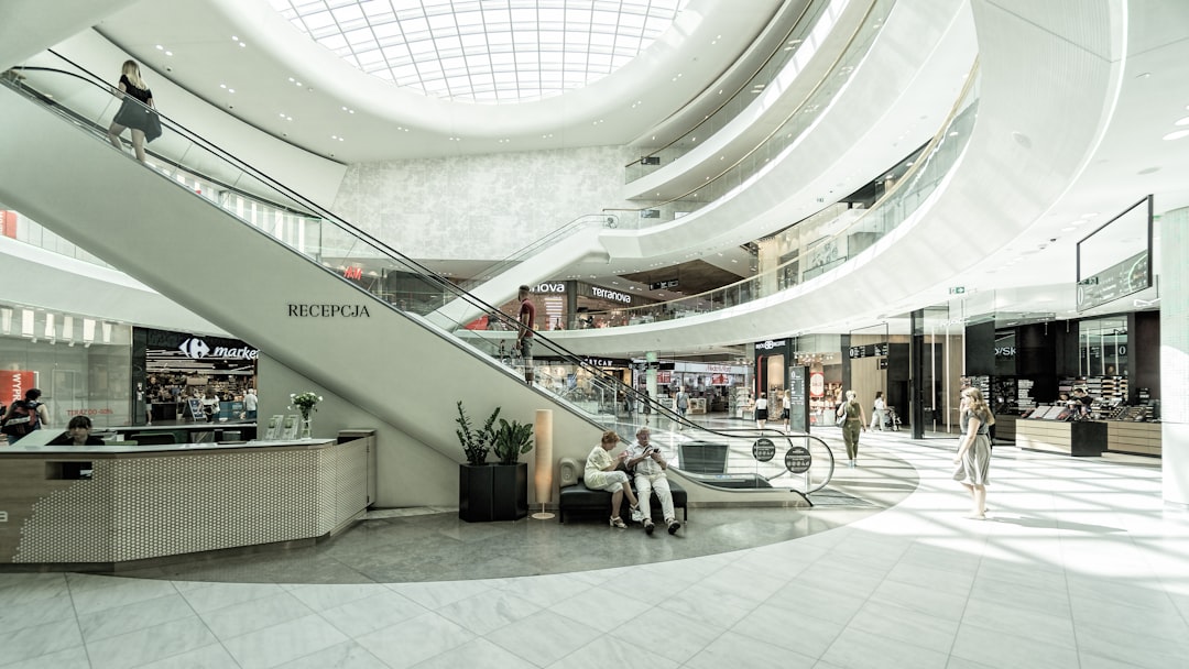 Shoppers walking inside modern mall