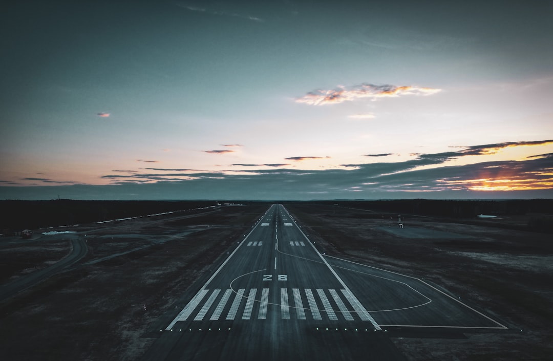 Aircraft taxiing at busy airport at sunset
