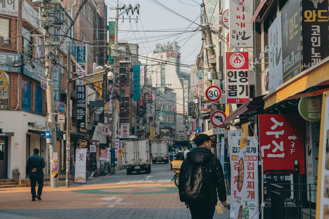 Busy Korean neighborhood shopping street at dusk